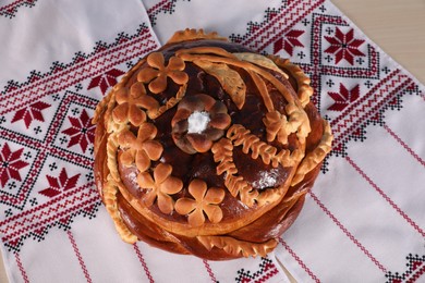 Photo of Korovai on rushnyk, top view. Ukrainian bread and salt welcoming tradition