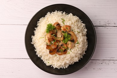 Photo of Delicious rice with parsley and mushrooms on white wooden table, top view