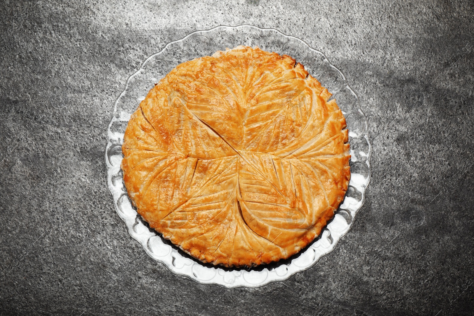 Photo of Traditional galette des rois on grey table, top view