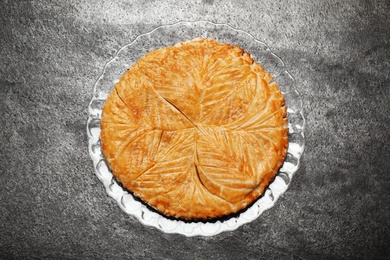 Traditional galette des rois on grey table, top view