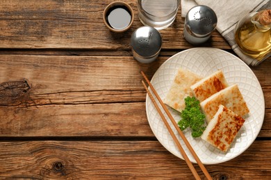 Photo of Delicious turnip cake with parsley served on wooden table, flat lay. Space for text