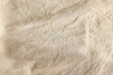 Beautiful beige fabric as background, top view