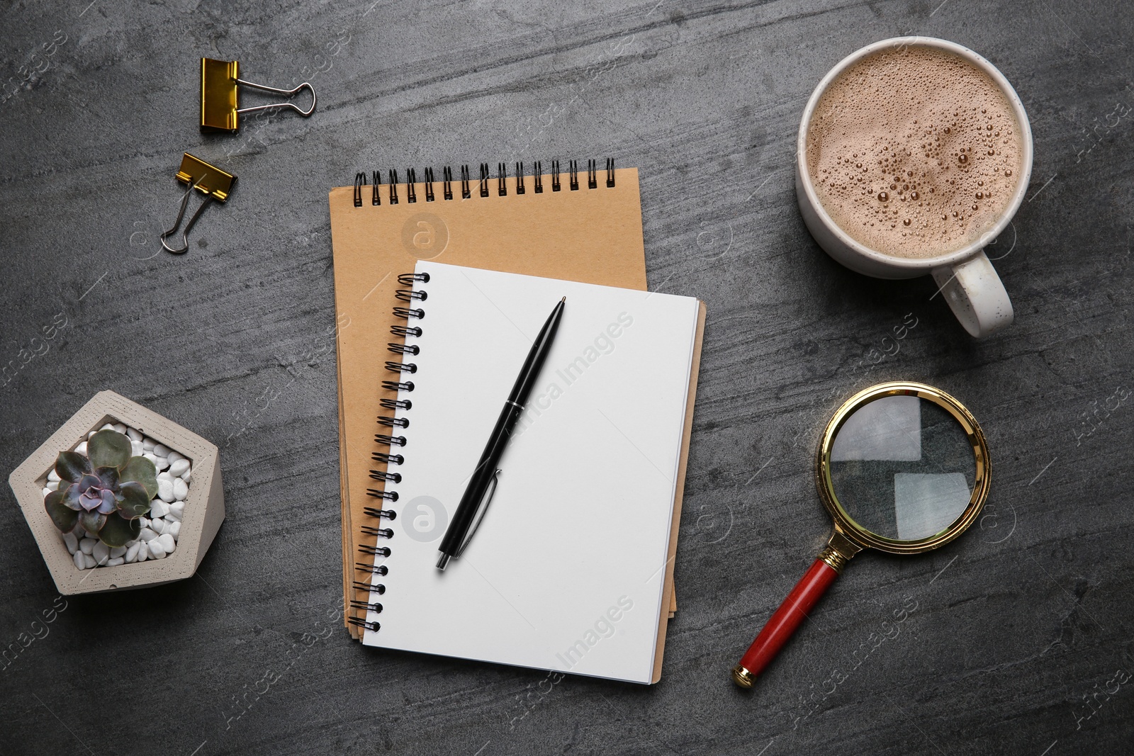 Photo of Flat lay composition with office stationery and cup of coffee on grey stone surface