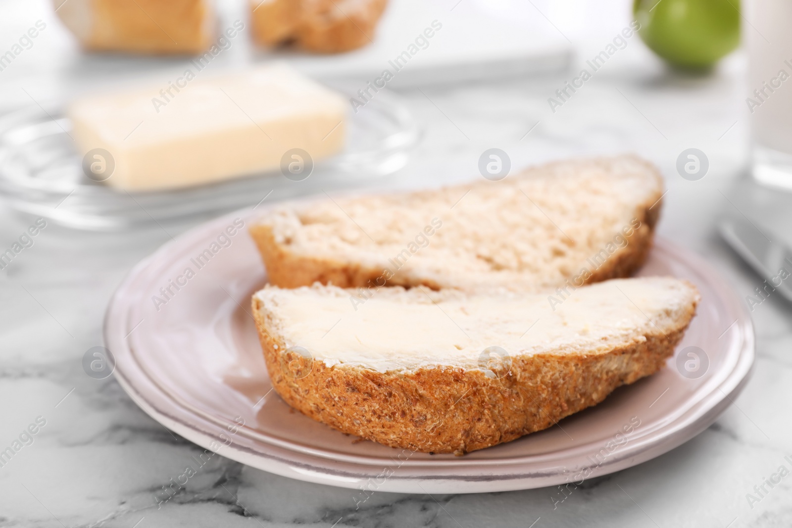 Photo of Fresh bread with tasty butter on plate