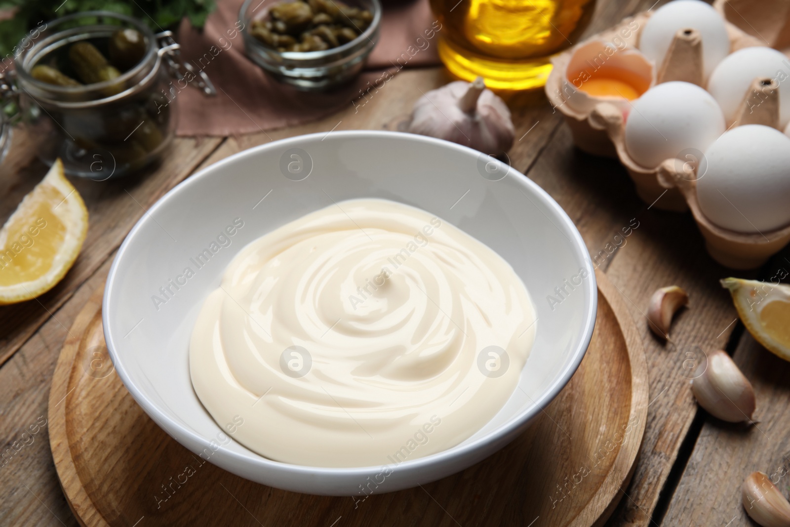 Photo of Composition with ingredients for tartar sauce on wooden table, closeup