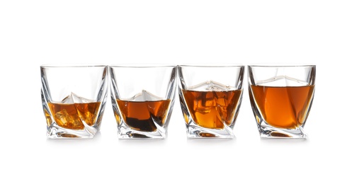 Photo of Glasses of scotch whiskey on white background, space for text