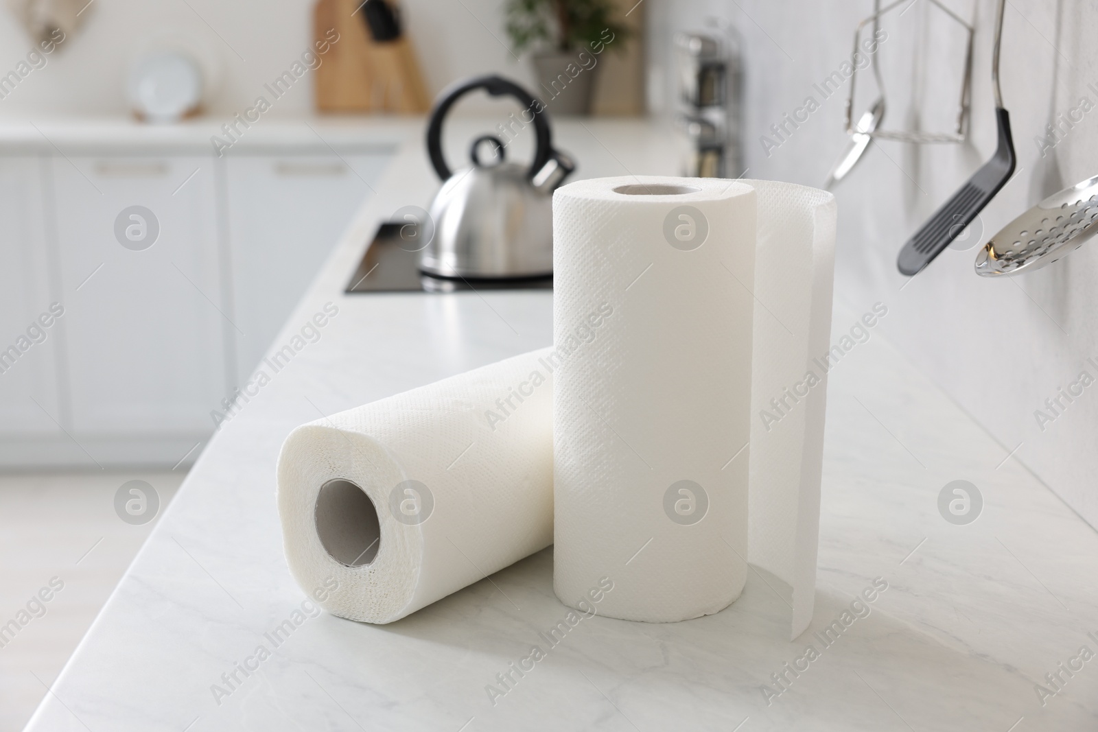 Photo of Rolls of paper towels on white countertop in kitchen