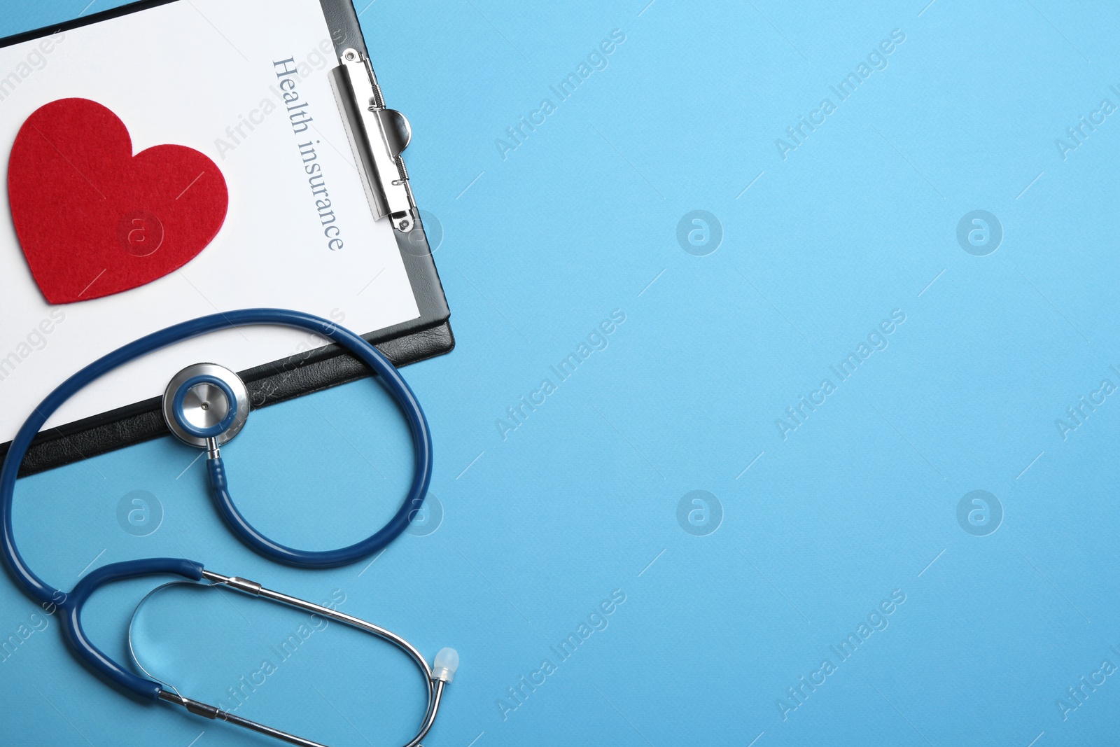 Photo of Flat lay composition with health insurance form and stethoscope on blue background, space for text