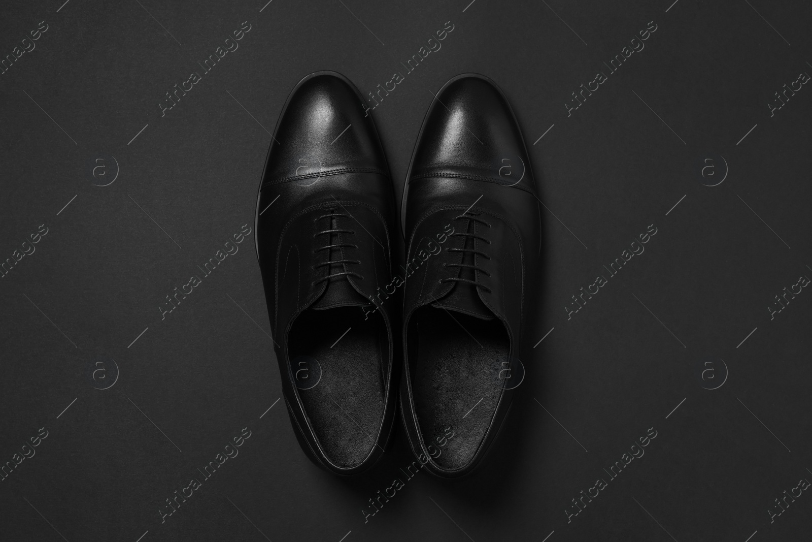 Photo of Pair of leather men shoes on black background, top view