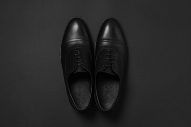 Photo of Pair of leather men shoes on black background, top view