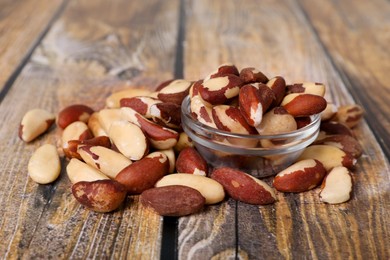 Photo of Many delicious Brazil nuts on wooden table