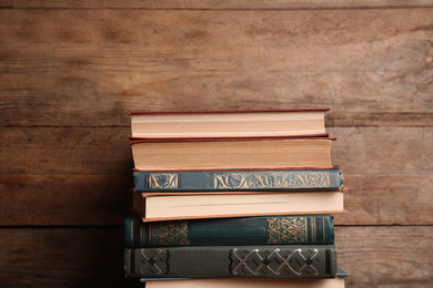 Collection of different books on wooden background