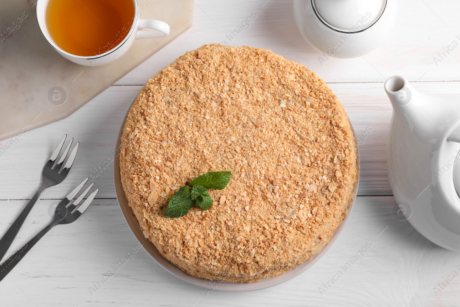 Photo of Delicious Napoleon cake served on white wooden table, flat lay