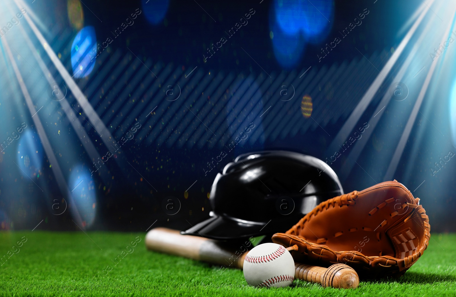 Image of Baseball bat, glove, helmet and ball on grass at stadium. Space for text