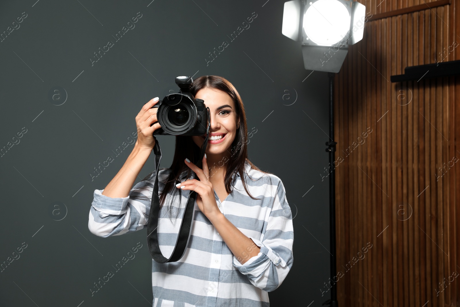 Photo of Professional photographer taking picture in modern studio