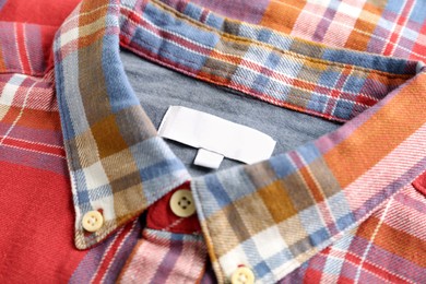Blank clothing label on checkered shirt, closeup