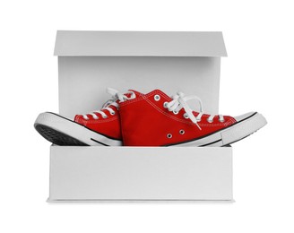 Photo of Pair of stylish sport shoes in box on white background