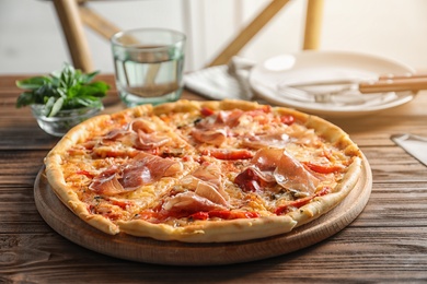 Delicious hot pizza with meat on table