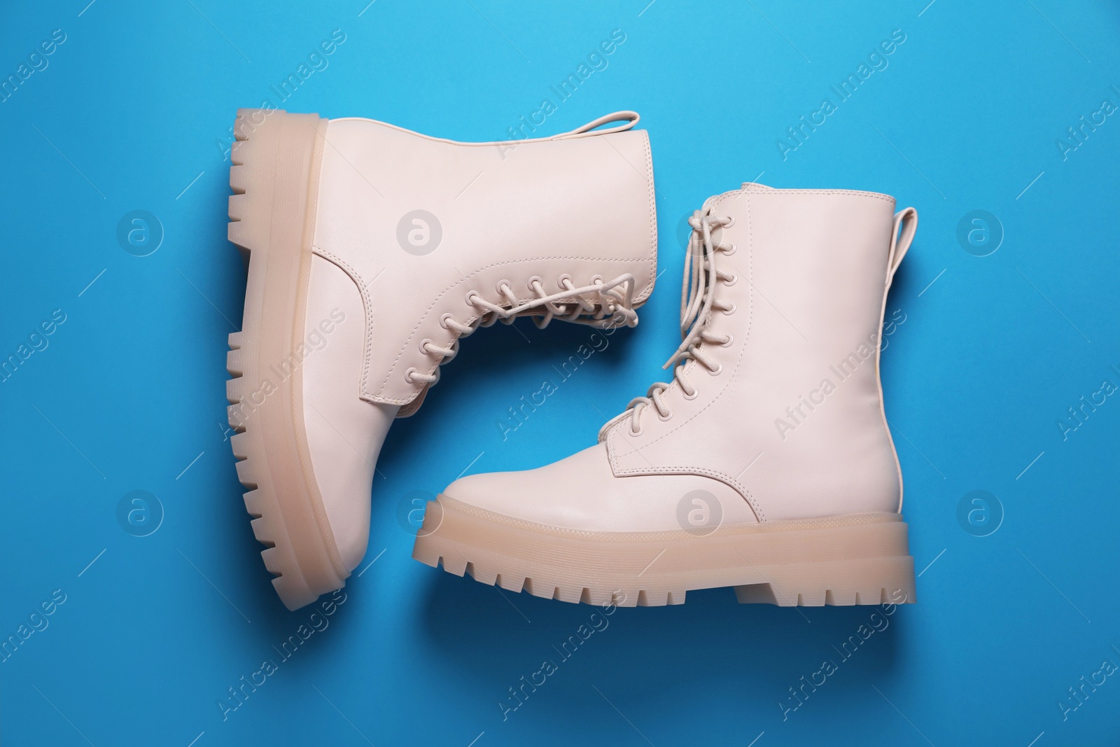 Photo of Pair of stylish leather shoes on light blue background, flat lay