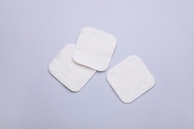 Photo of Clean cotton pads on light grey background, flat lay