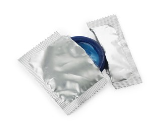 Photo of Condom in torn package on white background. Safe sex