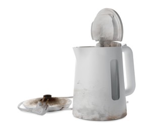 Burnt electric kettle with base and plug on white background