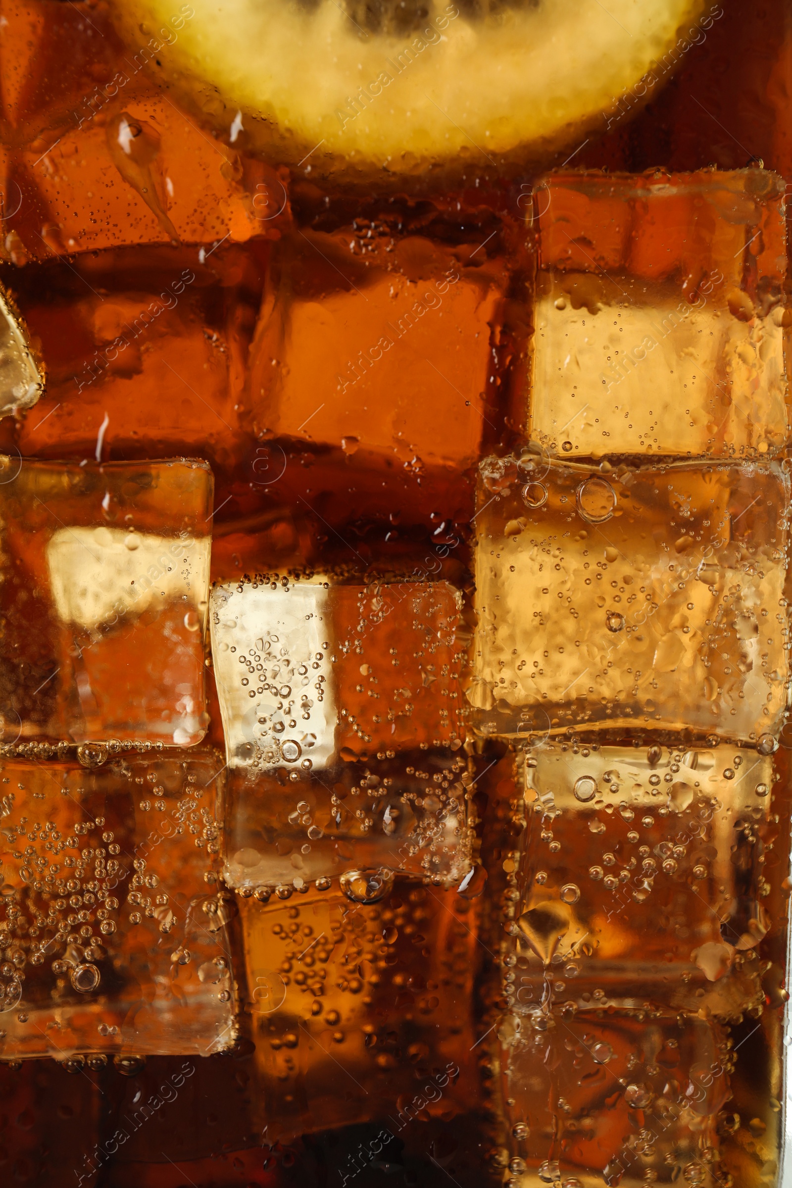 Photo of Closeup view of cold refreshing drink with ice and lemon slice in glass