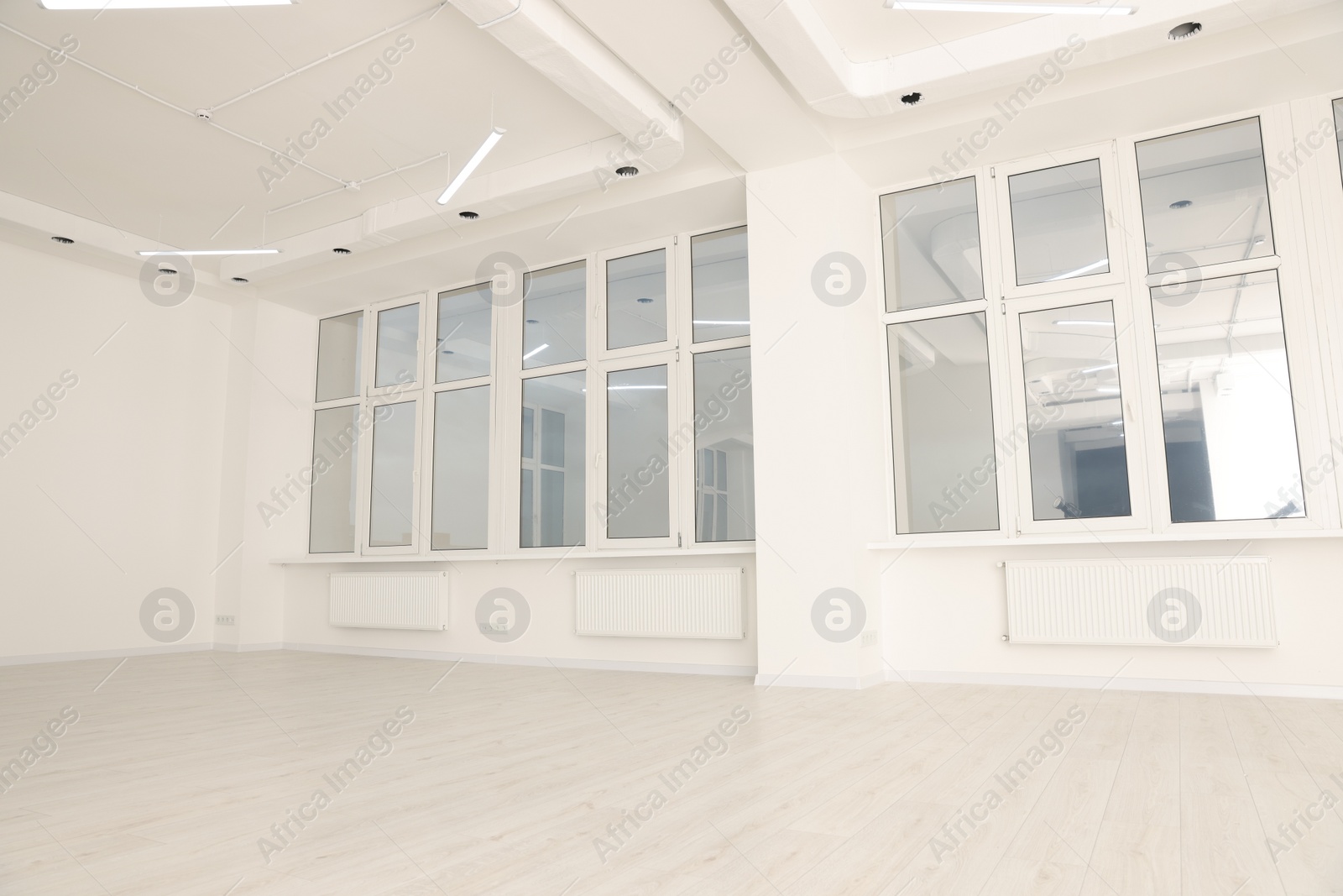 Photo of Modern office room with white walls and windows. Interior design