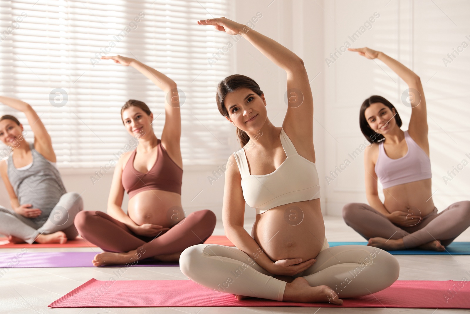 Photo of Group of pregnant women practicing yoga in gym