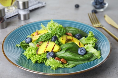 Delicious avocado salad with blueberries on grey table