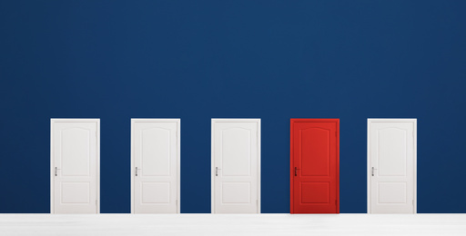 Image of Red door among white ones in room. Concept of choice