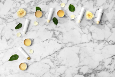 Photo of Flat lay composition with hygienic lipsticks and balms on light background