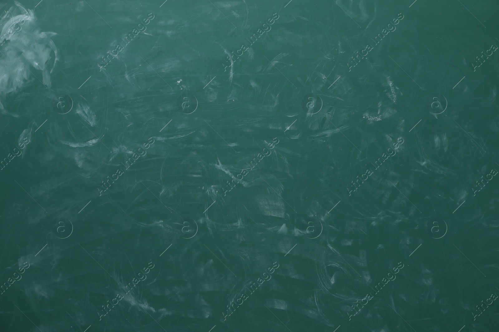 Photo of Chalk rubbed out on green chalkboard as background, closeup. Space for text