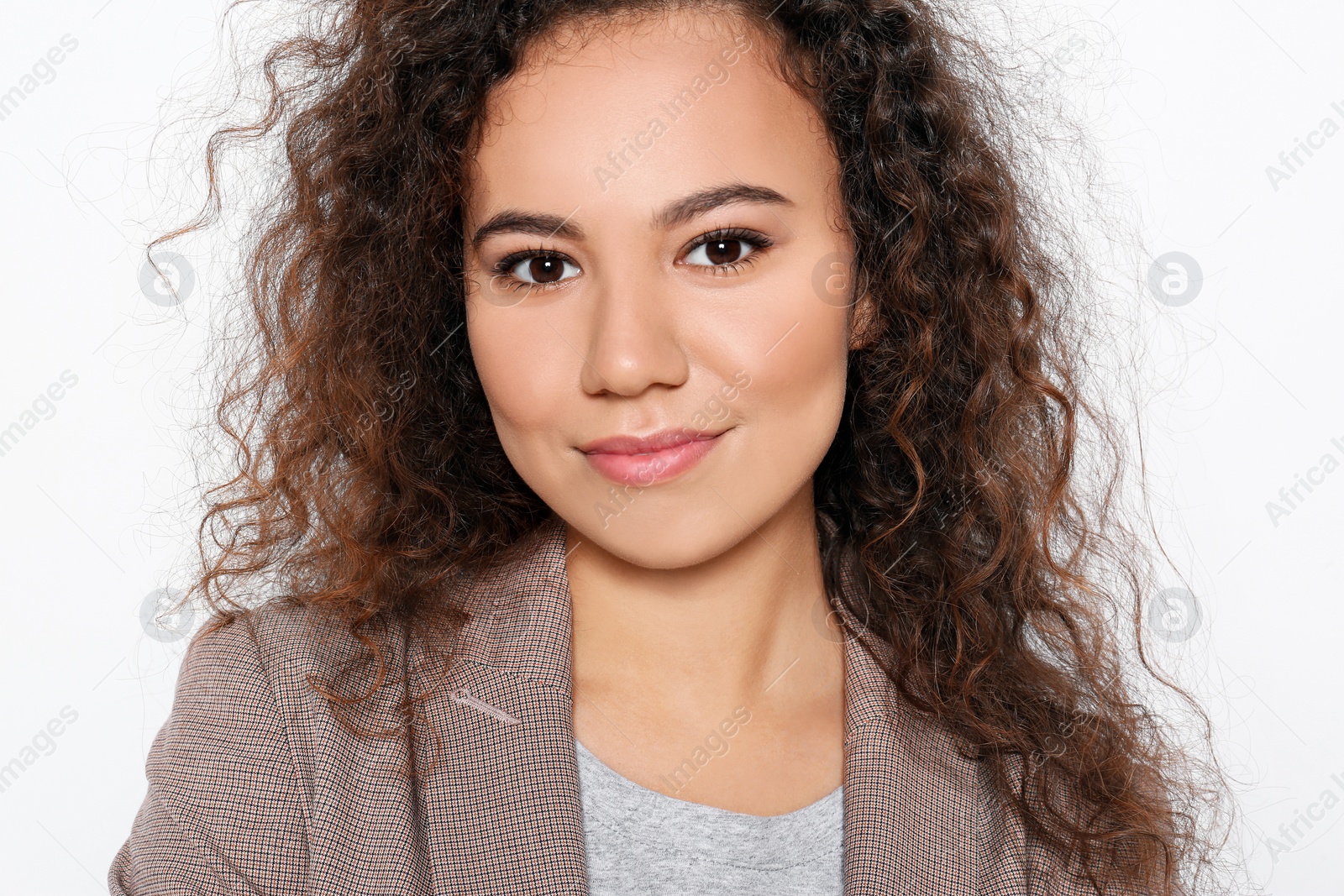 Photo of Young African-American woman with beautiful face on white background, closeup