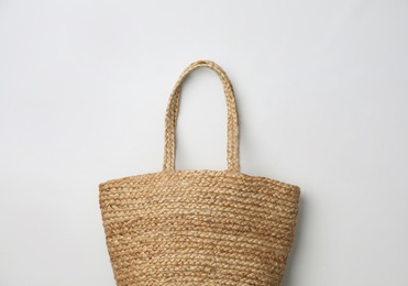 Stylish straw bag on white background, top view. Summer accessory