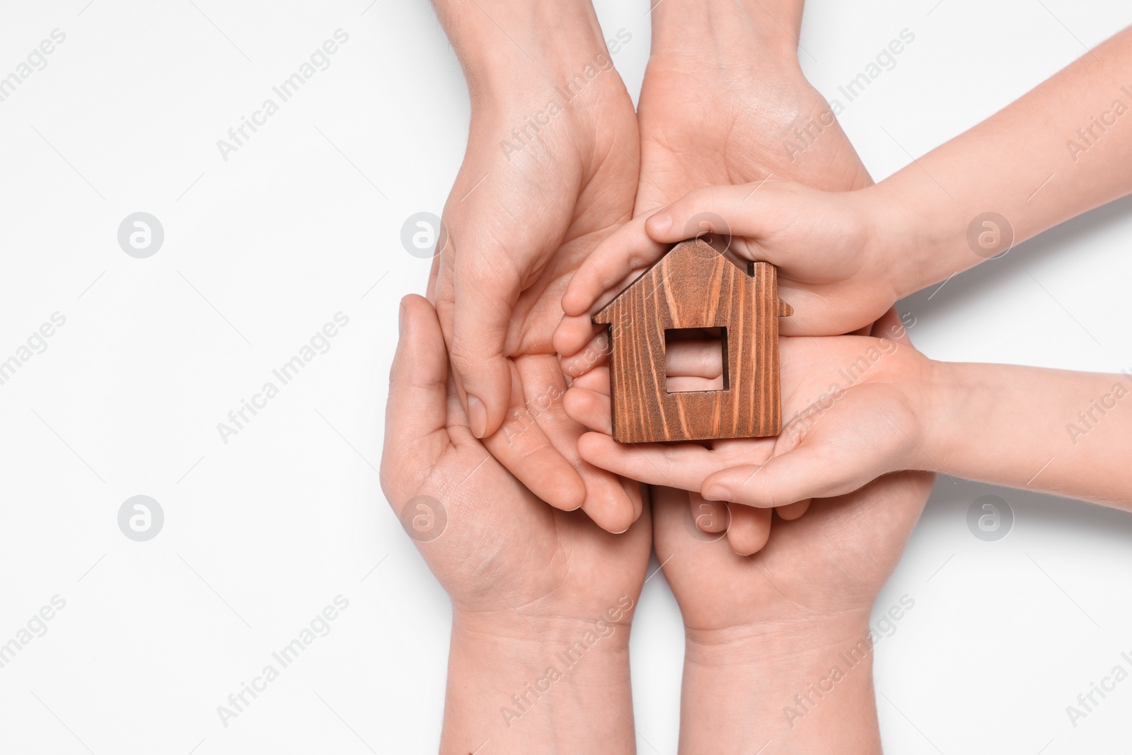 Photo of Home security concept. Family holding house model on white background, top view with space for text