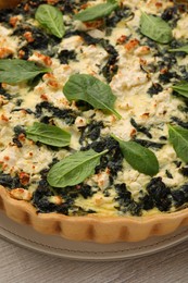 Photo of Delicious homemade spinach quiche on table, closeup