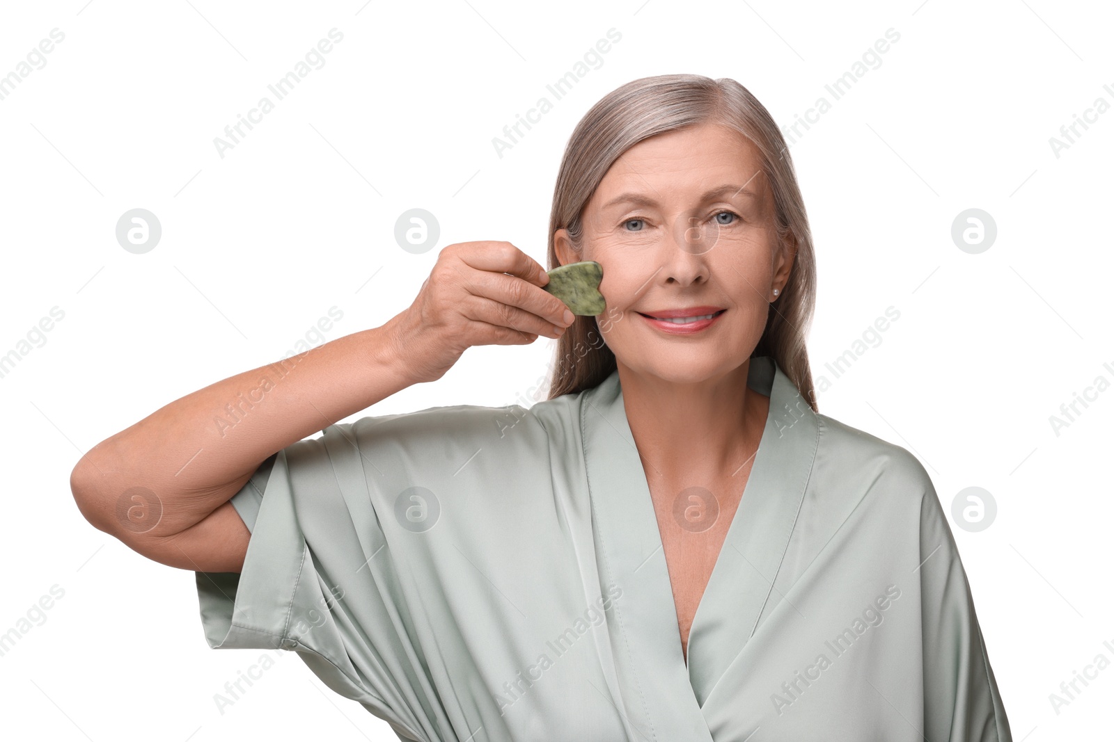 Photo of Woman massaging her face with jade gua sha tool isolated on white