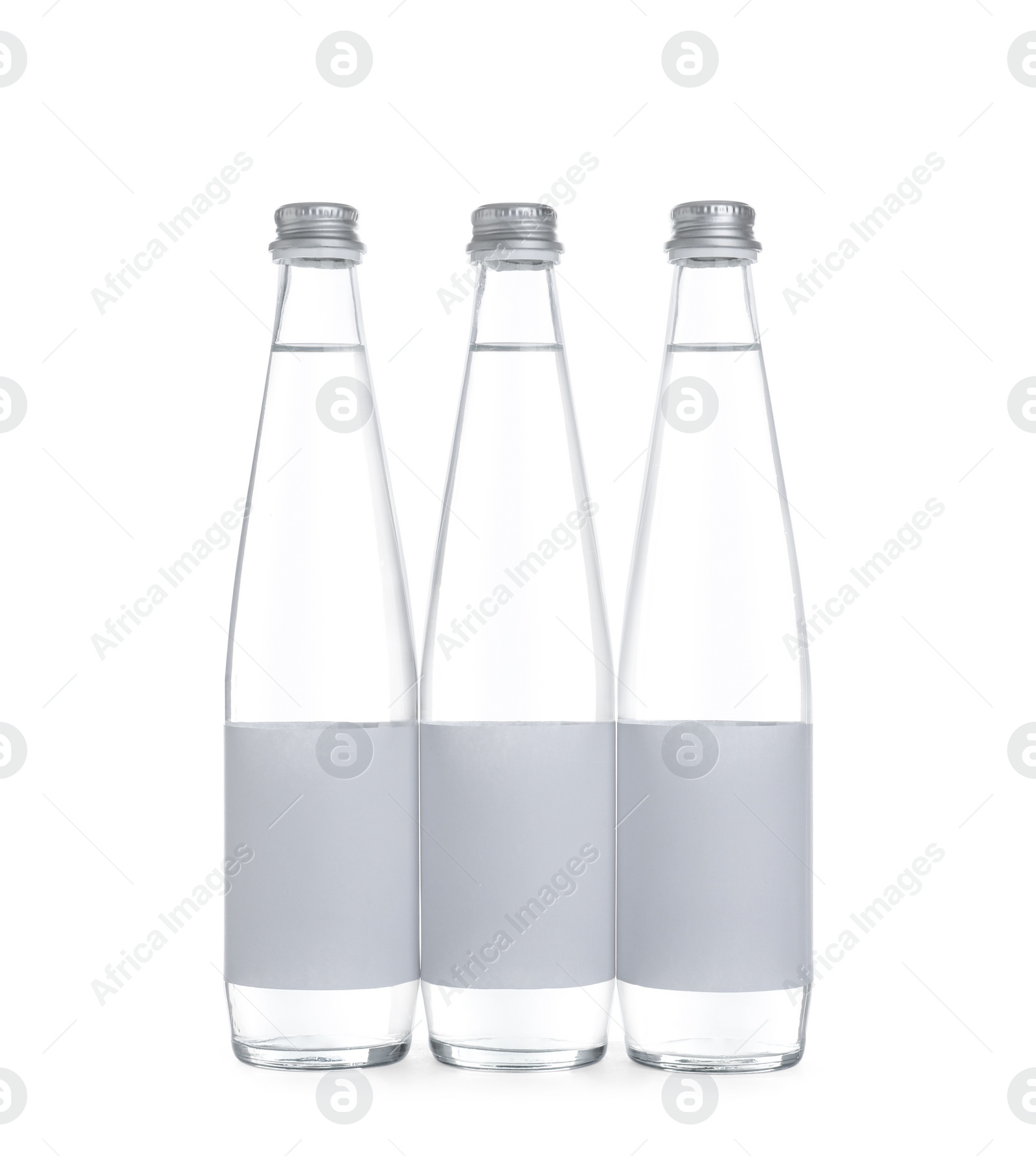 Photo of Glass bottles with soda water on white background