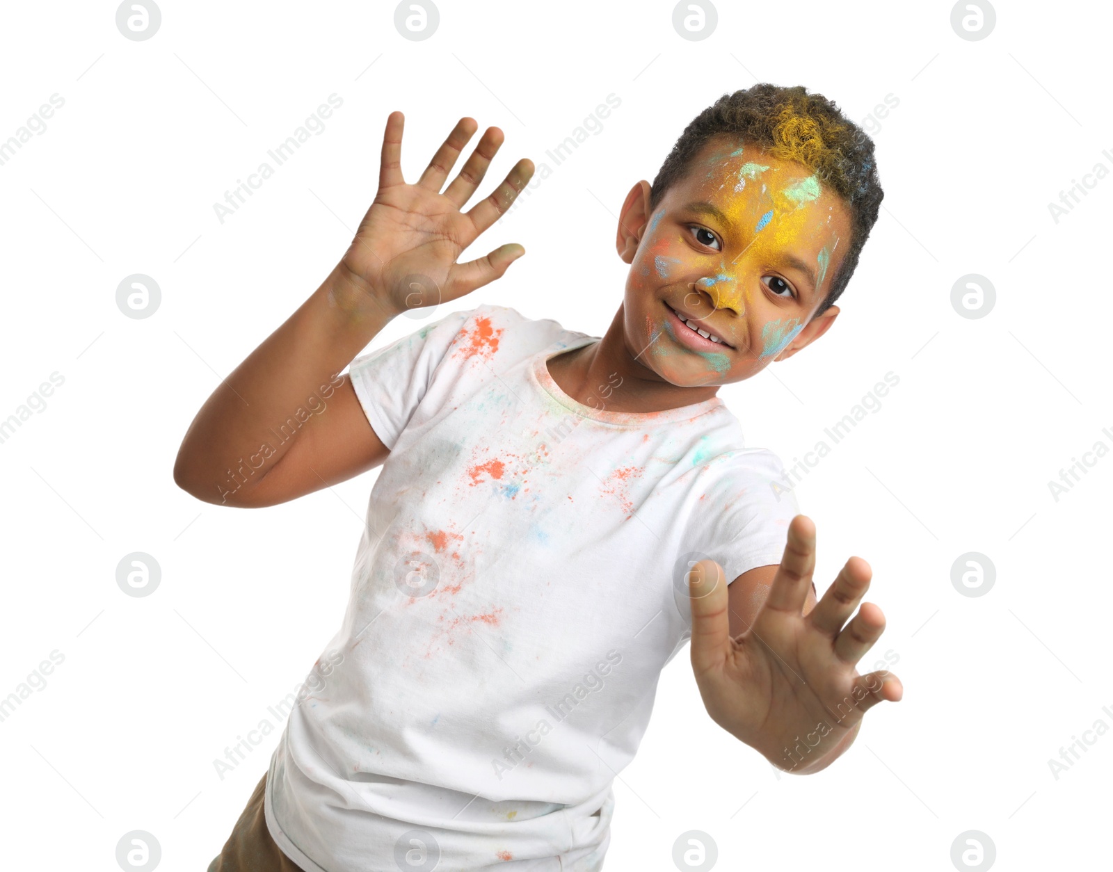 Photo of African American boy covered with colorful powder dyes on white background. Holi festival celebration