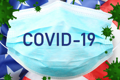 Image of Covid-19 outbreak. Virus flying over medical mask and American flag