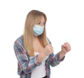 Photo of Woman with protective mask in fighting pose on white background. Strong immunity concept