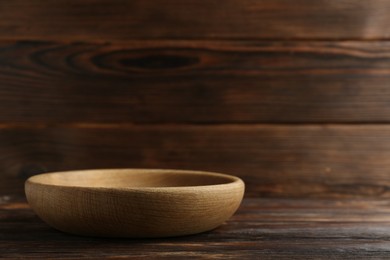 Photo of Beautiful bowl on wooden table, space for text