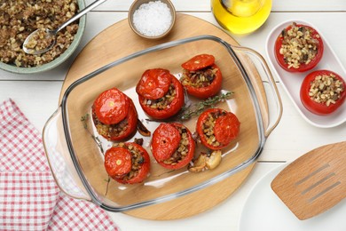 Delicious stuffed tomatoes with minced beef, bulgur and mushrooms on white table, flat lay