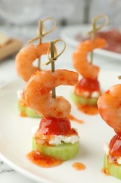 Photo of Tasty canapes with shrimps, vegetables and cream cheese on white table, closeup