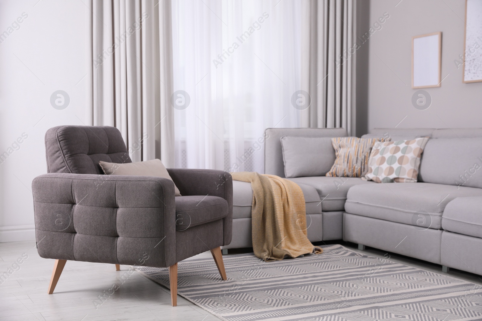 Photo of Stylish living room interior with comfortable armchair and sofa