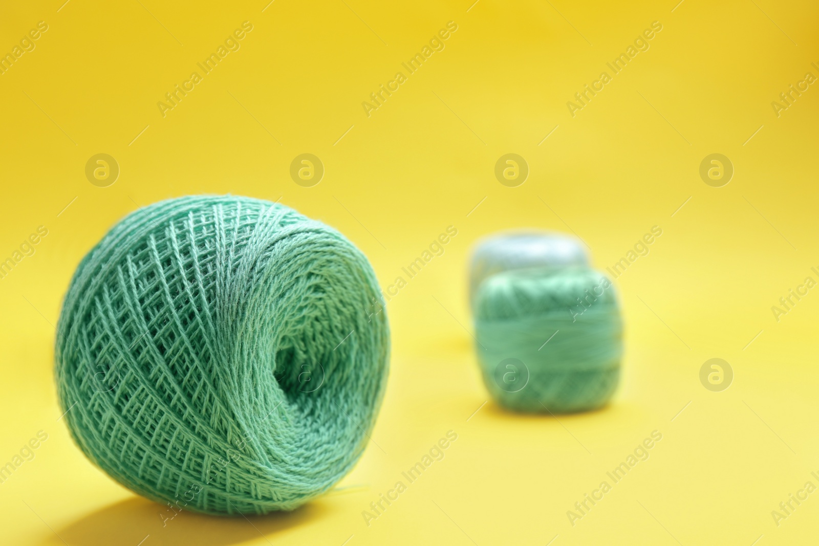 Photo of Clew of knitting threads on color background, space for text. Sewing stuff