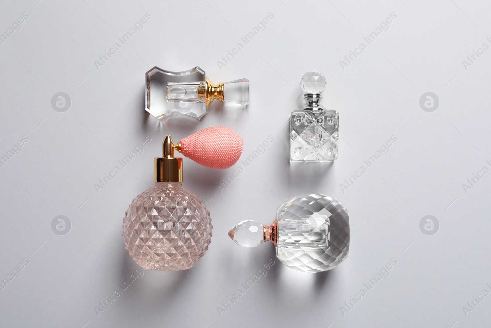 Photo of Flat lay composition with bottles of perfume on grey background