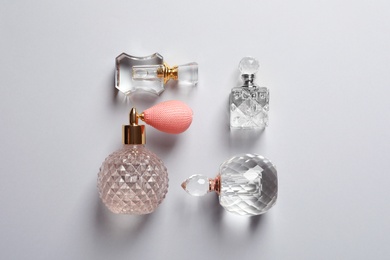 Photo of Flat lay composition with bottles of perfume on grey background