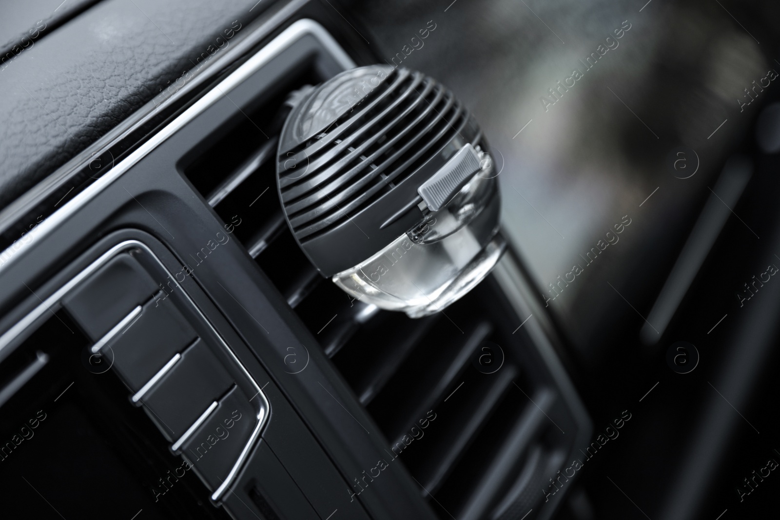 Photo of Stylish air freshener clip attached to car ventilation